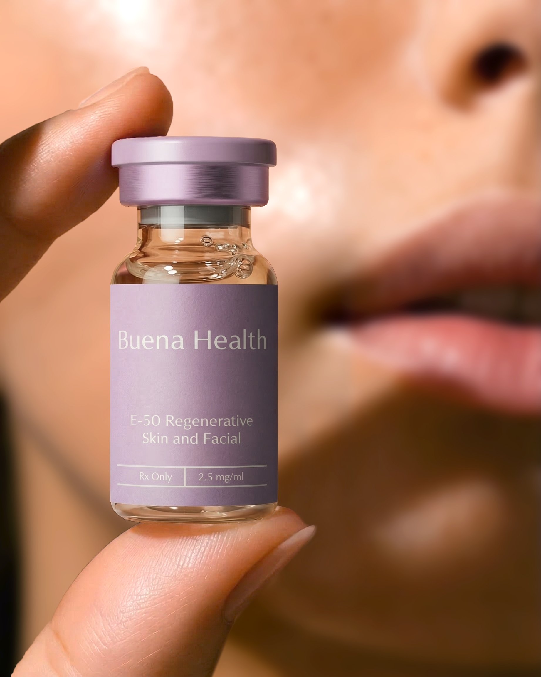 A patient holding the Buena Health E-50 Regenerative Skin and Facial vial to her face