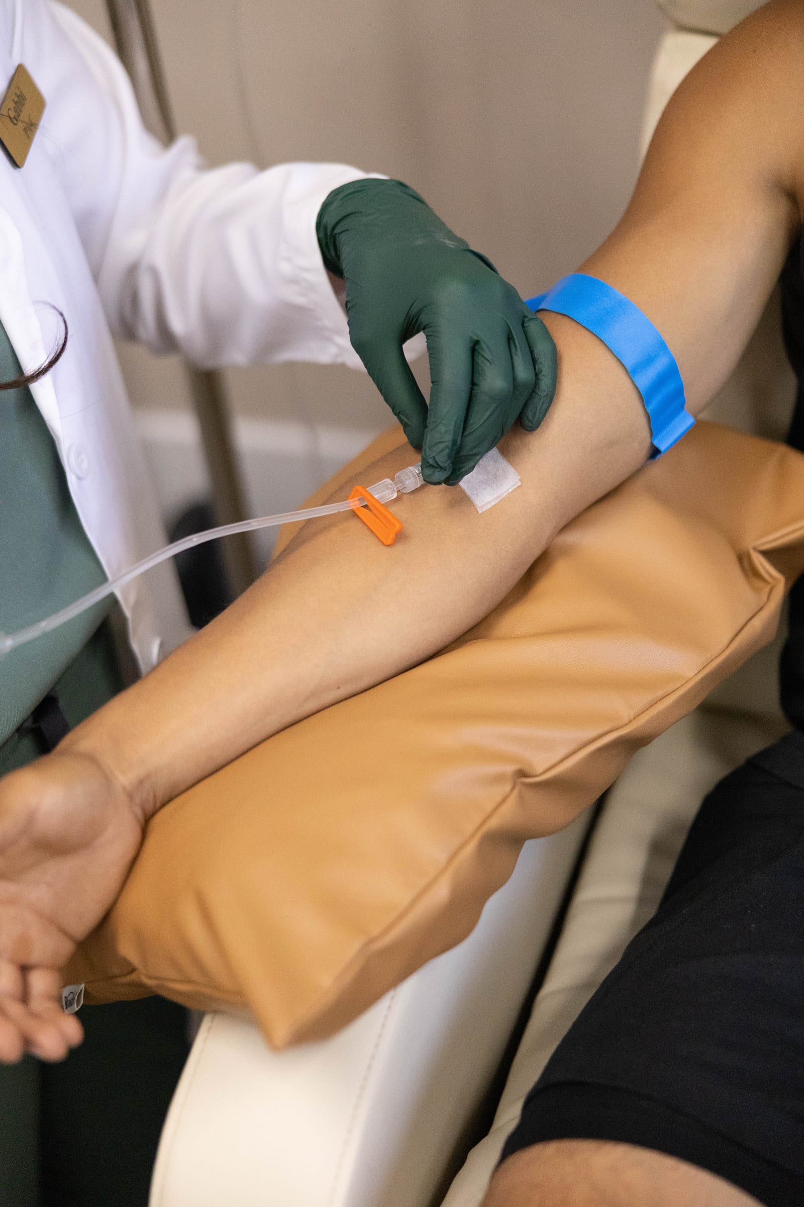 A Buena Health provider gently placing an IV line for a patient
